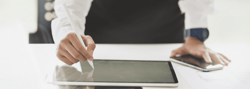 Woman signing her name on a iPad