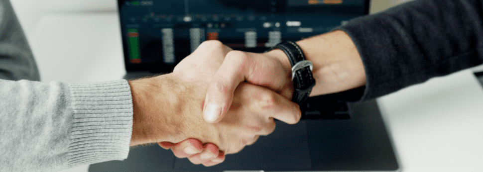 person shaking hands with employee benefits broker