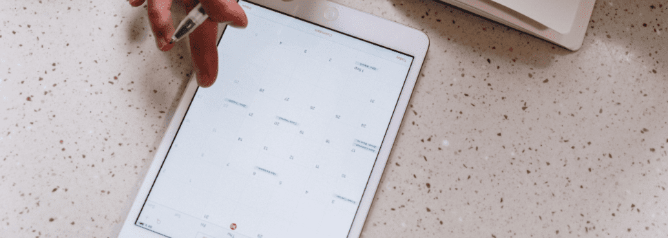 An electronic tablet opened to a calendar